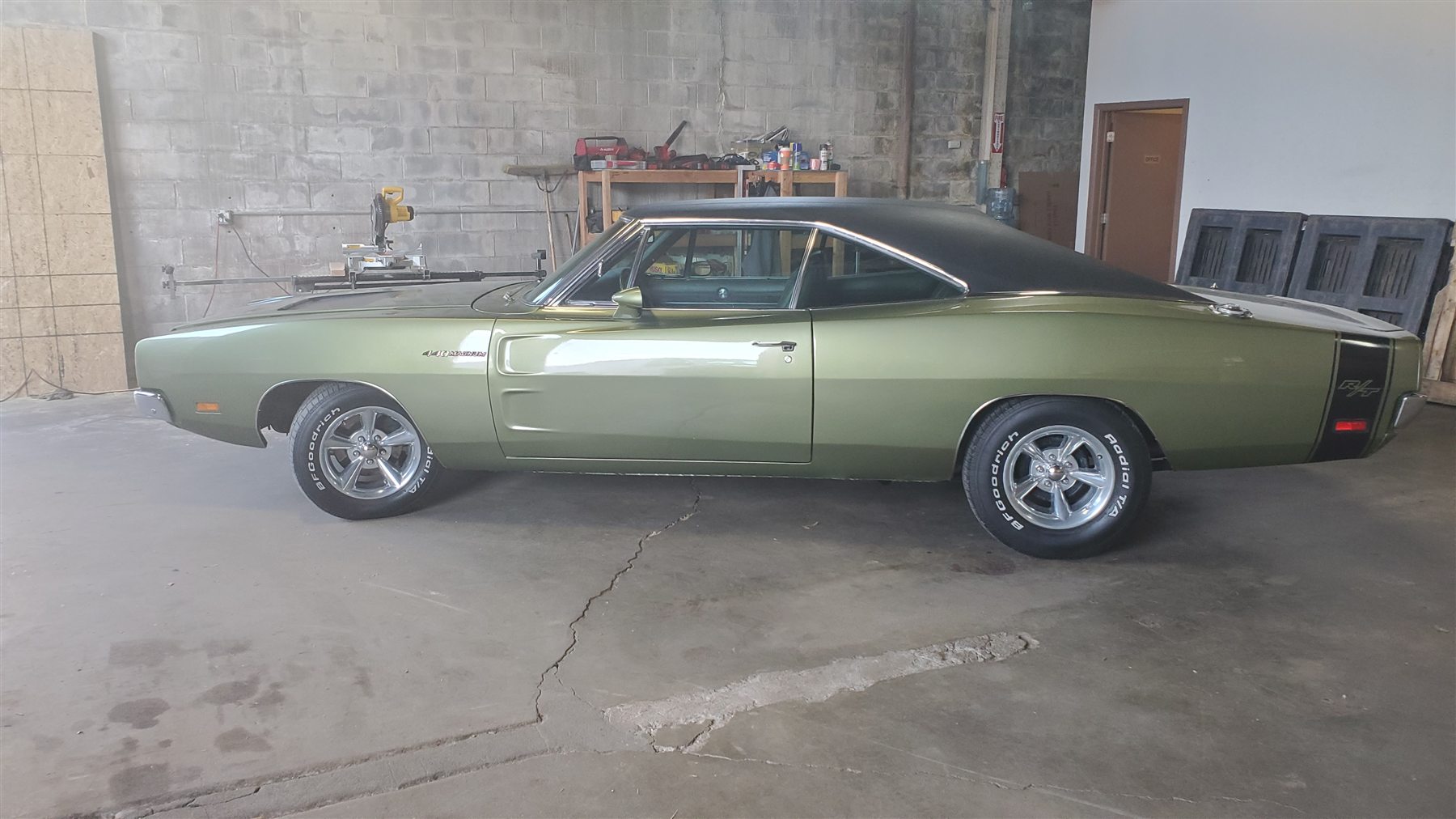 Green classic Dodge Charger inside the loading warehouse