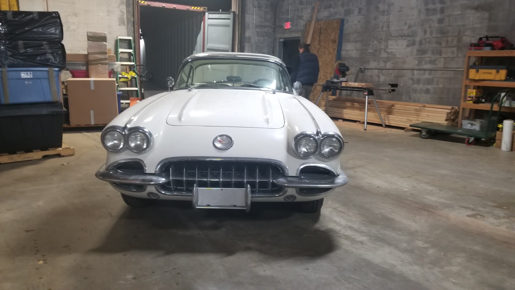 White classic Chevrolet Corvette staged in the warehouse before loading