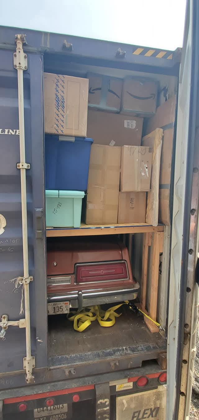 Boxes and parcels packed for international shipping inside a cargo container
