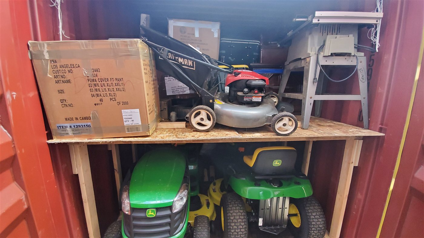 Smaller equipment and boxed cargo arranged in shared container space