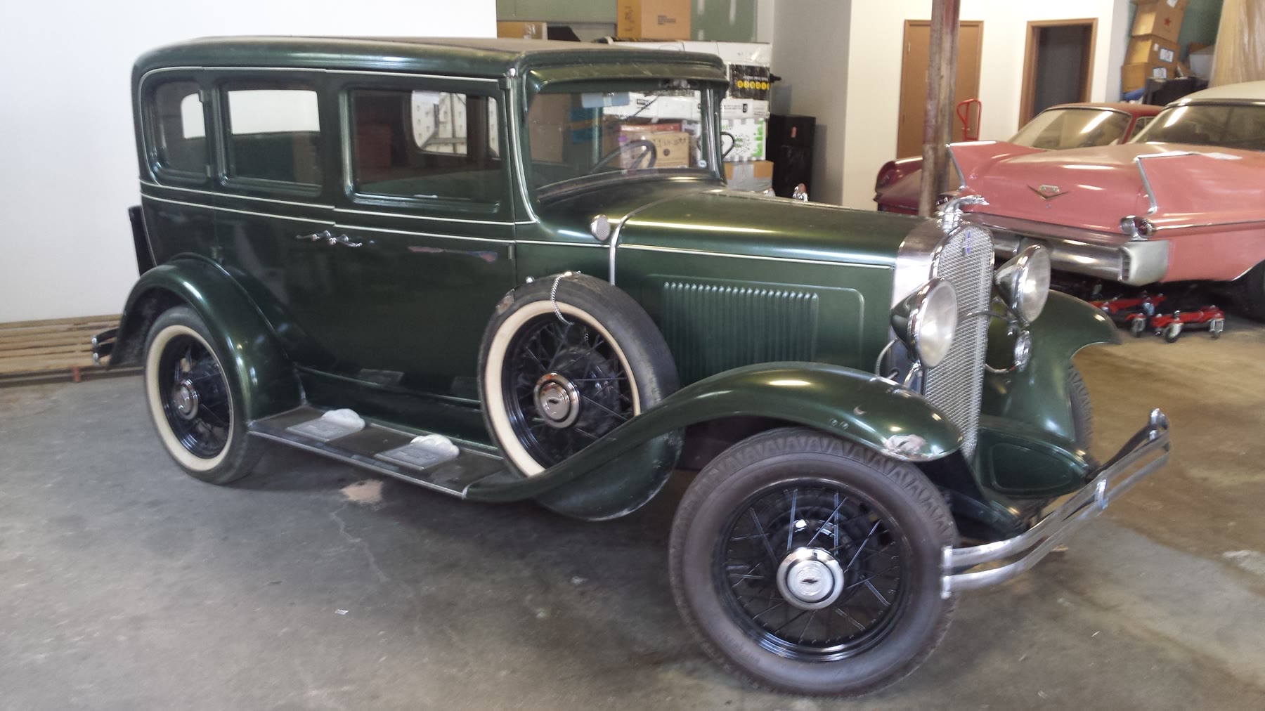 Dark green vintage American sedan prepared in the warehouse before shipping