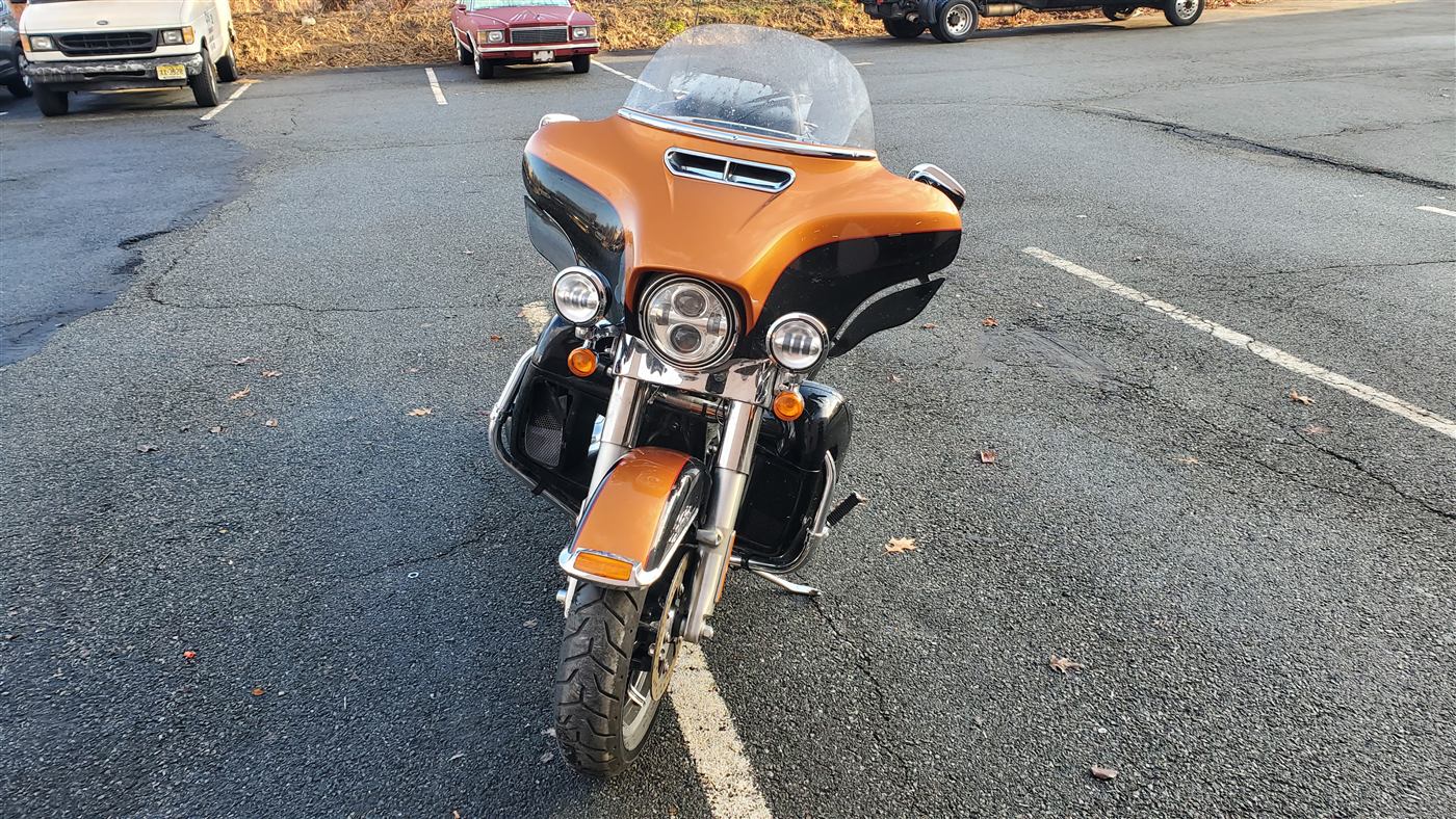Orange and black touring motorcycle before international vehicle shipping